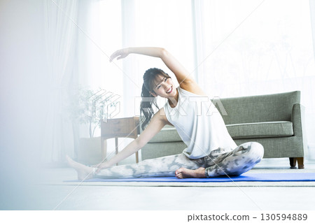 Young woman training at home Young woman training at home 130594889