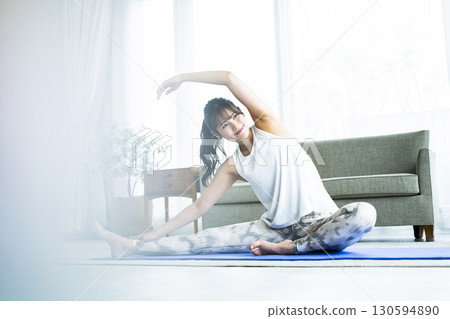 Young woman training at home Young woman training at home 130594890