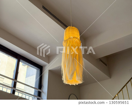 Hanging decorative lamp in interior. Warm light, creative design and cozy atmosphere in modern space. Hanging decorative lamp in interior. Warm light, creative design and cozy atmosphere in modern space. 130595651