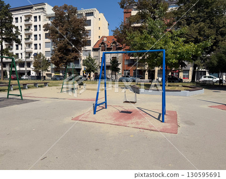 Empty playground with swings and climbing frames. Urban infrastructure and childhood leisure. Empty playground with swings and climbing frames. Urban infrastructure and childhood leisure. 130595691