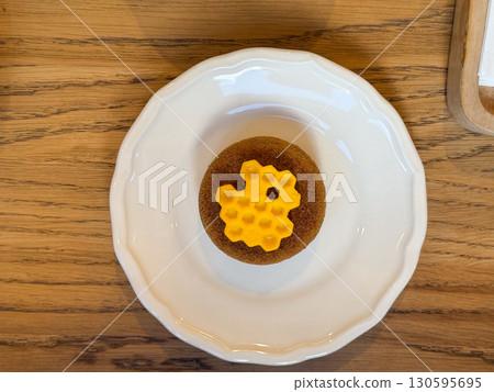 Elegant cake with honeycomb decoration. Creative dessert design and modern pastry art. 130595695