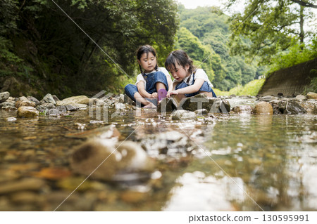 Sisters enjoying a summer vacation in the river Sisters enjoying a summer vacation in the river 130595991