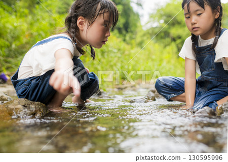 Sisters enjoying a summer vacation in the river Sisters enjoying a summer vacation in the river 130595996