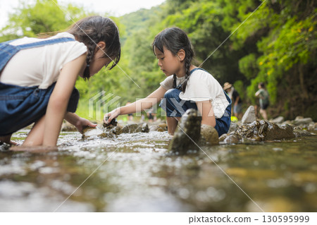 Sisters enjoying a summer vacation in the river 130595999