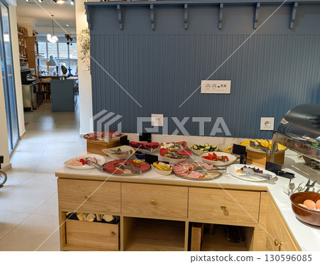 Cold buffet plates with fruits, vegetables, meats and cheese are neatly arranged on a counter. Dining culture, hospitality service, consumer lifestyle and culinary tradition in modern gastronomy. 130596085