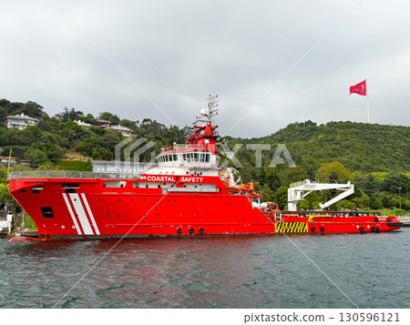 Large red maritime rescue ship in Istanbul port. Transportation, navigation, safety, security, and emergency service on Bosphorus Strait. Large red maritime rescue ship in Istanbul port. Transportation, navigation, safety, security, and emergency service on Bosphorus Strait. 130596121
