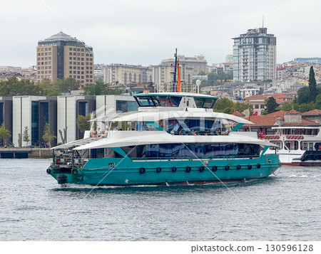 Modern green ferry sailing on Bosphorus in Istanbul. Public transport, tourism and city maritime connection. Modern green ferry sailing on Bosphorus in Istanbul. Public transport, tourism and city maritime connection. 130596128