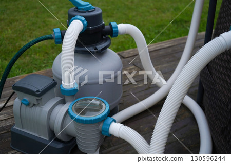 The outdoor pool's filtration system with a pump for ozone treatment and water purification. 130596244