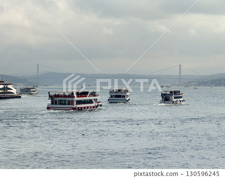 Passenger ferries moving across the Bosphorus. Maritime transport, city commuting, and coastal tourism in Istanbul. 130596245