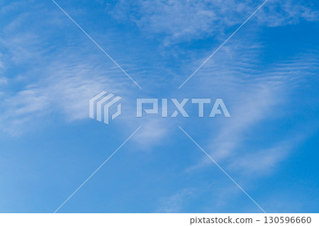A blurred background of the sky with dissolving translucent haze of clouds or other aerosols formed after the flight of aircraft. Bottom view with perspective, blank for artwork A blurred background of the sky with dissolving translucent haze of clouds or other aerosols formed after the flight of aircraft. Bottom view with perspective, blank for artwork 130596660