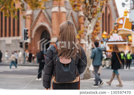 woman traveler visiting in Shanghai, China. Happy Female Tourist sightseeing Shanghai Union Church view in autumn season. landmark and popular for tourism attractions. Travel and vacation woman traveler visiting in Shanghai, China. Happy Female Tourist sightseeing Shanghai Union Church view in autumn season. landmark and popular for tourism attractions. Travel and vacation 130597470