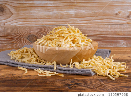 Passatelli spatzle pasta in bowl, raw spaetzle noodles, dry homemade german macaroni 130597968