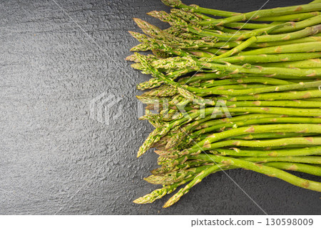 Bunch of Raw Garden Asparagus Textured Background. Fresh Green Spring Vegetables 130598009