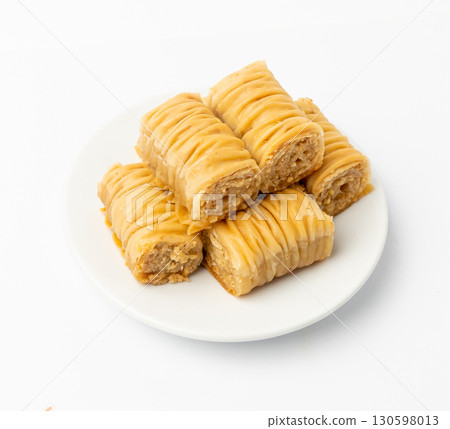Rolled Baklava Isolated, Ramadan Dessert Roll on Restaurant Plate, Eastern Sweet Pastries Rolled Baklava Isolated, Ramadan Dessert Roll on Restaurant Plate, Eastern Sweet Pastries 130598013