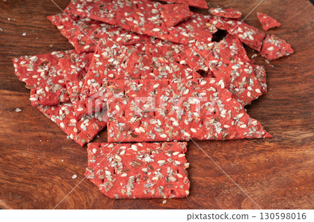 Beetroot crackers, thin rusk beet root bread, red diet multigrain crispbread, various seeds 130598016