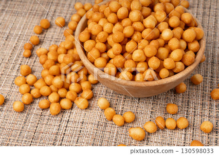 Small pastry balls, fried crispy wheat soup pearls, salad egg puffs or choux pastry Small pastry balls, fried crispy wheat soup pearls, salad egg puffs or choux pastry 130598033
