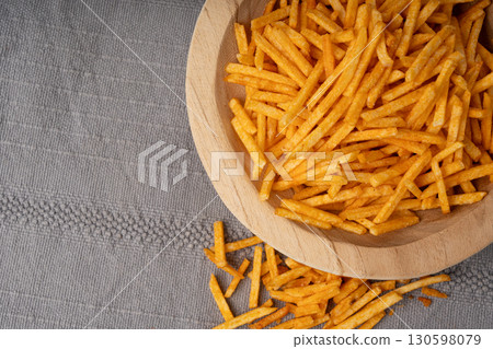 Fried chips sticks, finger potato chips, golden shoestring fries pile, French fries 130598079