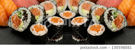 Set of Various Japanese Sushi Food on Dark Sate Plate Closeup. Nigiri and Nori Maki Sushi Rolls 130598081