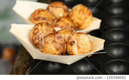 Takoyaki - traditional Japanese street food, outdoor snack with octopus Takoyaki fried balls 130598082