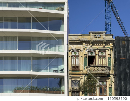 Contrast of architecture in Porto, Portugal, showing an ornate historic building with decorative Contrast of architecture in Porto, Portugal, showing an ornate historic building with decorative 130598590