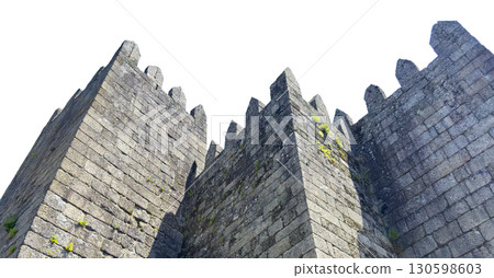 Medieval fortress walls of Guimaraes Castle in Portugal, isolated on white background. The stone Medieval fortress walls of Guimaraes Castle in Portugal, isolated on white background. The stone 130598603
