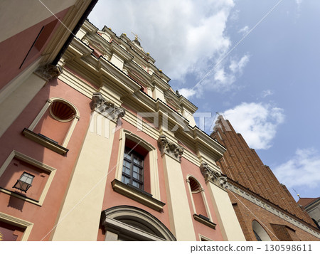 Low angle view of a historic church facade in Warsaw, Poland. The ornate baroque architecture is 130598611
