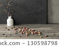 Atmospheric art floral still life, copy space. White gypsum vase and dry roses buds on table surface and dark grey background. 130598798