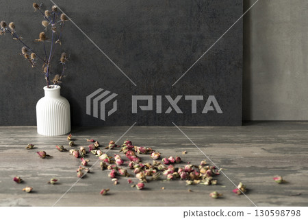 Atmospheric art floral still life, copy space. White gypsum vase and dry roses buds on table surface and dark grey background. 130598798