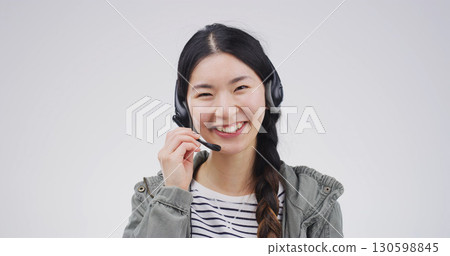 Woman, portrait or headset in studio for consultation, customer support or translation service. Call center, Asian employee or happy on white background for contact, help desk or company FAQ at space 130598845