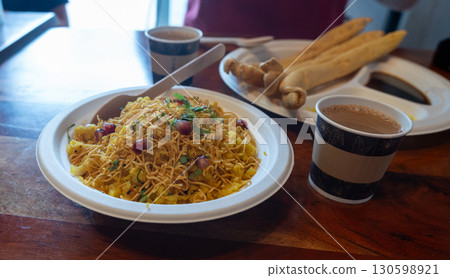 Poha Indian breakfast food close up. Healthy pohe rice flakes dish 130598921