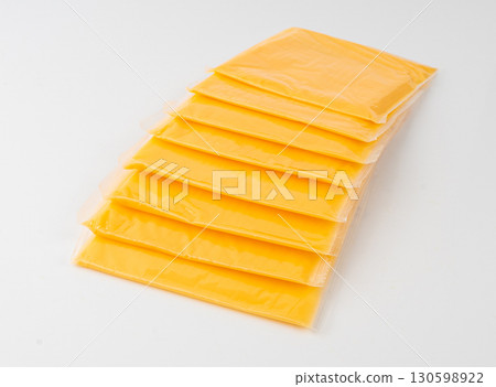 American cheese, processed cheese slice, wrapped thin yellow cheddar in a plastic package American cheese, processed cheese slice, wrapped thin yellow cheddar in a plastic package 130598922