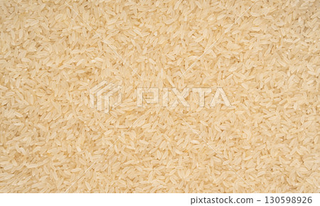 White parboiled rice grains. Dry uncooked ponni rice, small organic basmati 130598926
