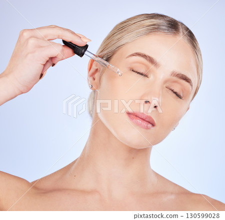 Face, eyes closed and skincare of woman with serum in studio isolated on a purple background. Dermatology, beauty cosmetics and female model apply hyaluronic acid, retinol or essential oil product Face, eyes closed and skincare of woman with serum in studio isolated on a purple background. Dermatology, beauty cosmetics and female model apply hyaluronic acid, retinol or essential oil product 130599028