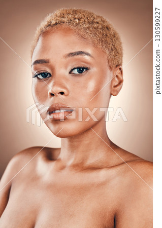Beauty, skincare and portrait of black woman with glowing skin in studio on brown background. Natural makeup, spa facial promotion and advertising luxury cosmetics on model face with golden shine. Beauty, skincare and portrait of black woman with glowing skin in studio on brown background. Natural makeup, spa facial promotion and advertising luxury cosmetics on model face with golden shine. 130599227