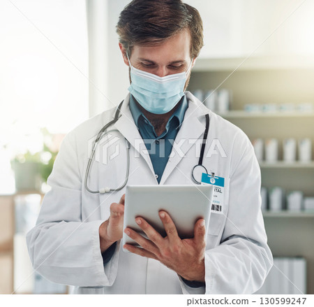 Healthcare, tablet and doctor with mask for medical care, wellness and research analysis in hospital. Covid, insurance and health worker on digital tech for internet, patient data and telehealth app 130599247