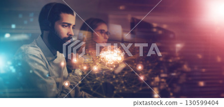 Businessman, woman and overlay in night at office for crm teamwork, tech support consulting and it help desk. Information technology, call center and consultant team focus with 3D hologram abstract Businessman, woman and overlay in night at office for crm teamwork, tech support consulting and it help desk. Information technology, call center and consultant team focus with 3D hologram abstract 130599404