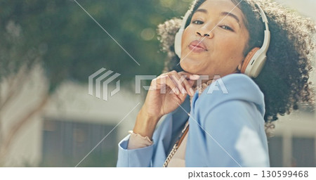 Music, outdoor and black woman dance with headphones, freedom and streaming hip hop or radio sound. Energy, crazy fun and portrait of dancer listening to a song or moving to audio in city with space 130599468