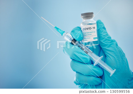 Doctor, hands and covid vaccine for cure, healthcare or medical syringe medication to combat the virus. Hand of nurse holding corona virus sample with needle for vaccination from illness or disease Doctor, hands and covid vaccine for cure, healthcare or medical syringe medication to combat the virus. Hand of nurse holding corona virus sample with needle for vaccination from illness or disease 130599556