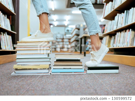 Woman feet, book steps and library for symbol of progress in learning, education and development for study goals, University student, cropped and shoes with paper stairs on floor to success vision 130599572