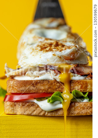club sandwich on yellow background 130599679
