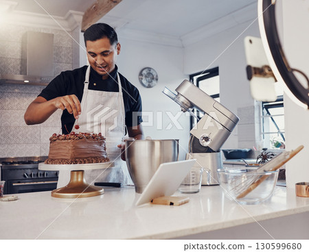 Man, vlog and baking chocolate cake in kitchen, live streaming and recording a dessert tutorial on social media. Happy chef, digital content creator or food influencer filming a virtual cooking class 130599680