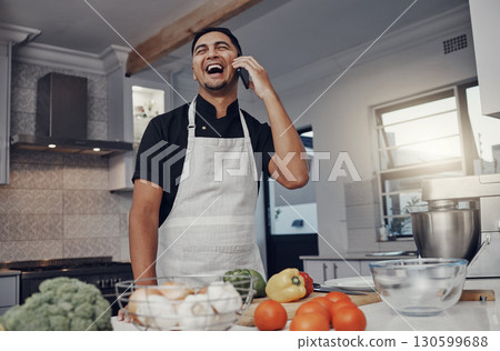 Man, phone call and laughing or cooking in kitchen for healthy nutrition, food diet and organic vegetables salad. Young male, chef happiness and smile for smartphone call or cook dinner in home Man, phone call and laughing or cooking in kitchen for healthy nutrition, food diet and organic vegetables salad. Young male, chef happiness and smile for smartphone call or cook dinner in home 130599688