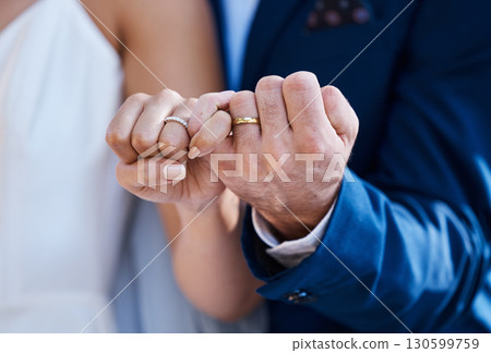 Hands, pinky promise and wedding ring of bride with groom for outdoor celebration of partnership, care and love. Marriage commitment and trust of interracial couple at event with togetherness zoom Hands, pinky promise and wedding ring of bride with groom for outdoor celebration of partnership, care and love. Marriage commitment and trust of interracial couple at event with togetherness zoom 130599759