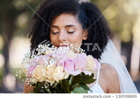 Eyes closed, bride and black woman with flowers at wedding outdoors. Face, marriage and beauty of female smelling floral bouquet of roses to celebrate at party, ceremony event or love celebration 130599800
