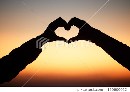 Sunset, hands in heart and silhouette of couple at beach for romantic vacation, holiday and adventure. Emoji, travel and sky shadow of people relax, calm and together for trust, commitment and love Sunset, hands in heart and silhouette of couple at beach for romantic vacation, holiday and adventure. Emoji, travel and sky shadow of people relax, calm and together for trust, commitment and love 130600032