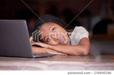 Bored black woman, laptop and thinking in remote work resting head on table in thought for business plan. Tired African female freelancer wondering, dreaming or relaxed by computer contemplating idea 130600166