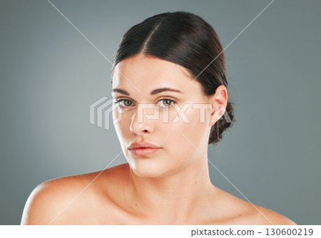 Facial beauty, portrait and woman in studio for skincare, wellness and cosmetics. Young female model, face headshot and aesthetic dermatology, healthy shine and natural glow from body salon results 130600219