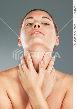Woman, beauty and skincare holding neck in satisfaction for cosmetic treatment against grey studio background. Portrait of beautiful female touching soft, smooth or perfect skin for healthy wellness 130600243