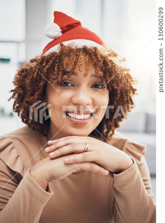 Santa hat, black woman and portrait of a female at home getting ready for christmas and holiday. House, smile and happiness of a young person celebrating holidays in an apartment with fun accessories 130600299