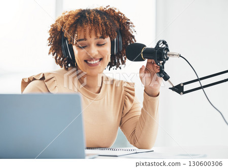 Laptop, microphone and media with a black woman presenter talking during a broadcast while live streaming. Influencer, talk show and radio with a female journalist or host chatting on a mic 130600306